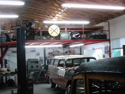 1978 Ford Bronco - A two-tone station wagon is parked in a garage, with another vehicle partially visible in the foreground.