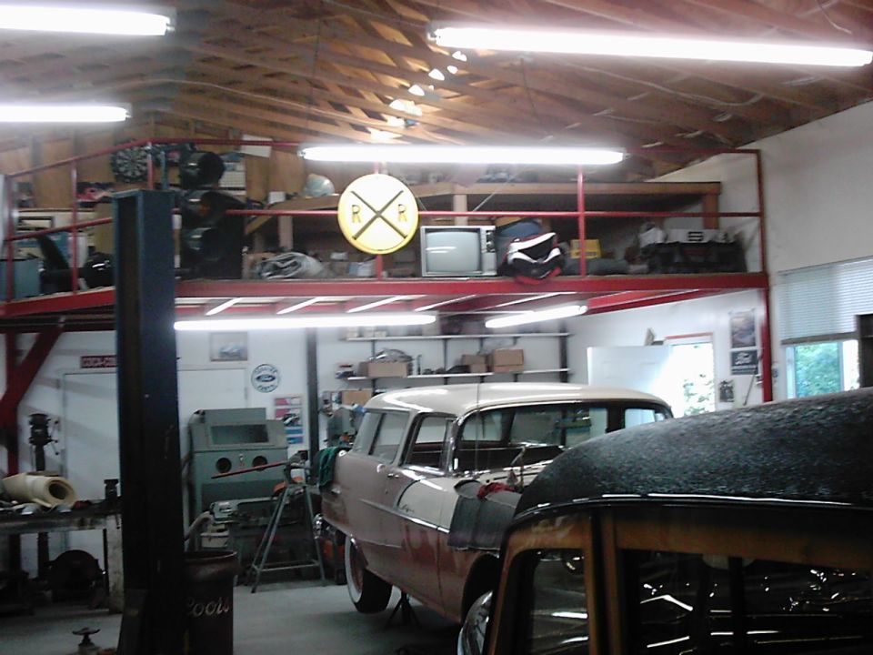 Two-tone station wagon in garage, side view. 1955 model