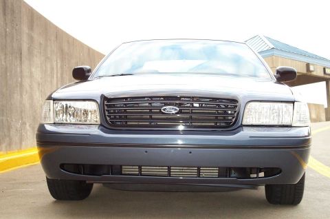 1998 Ford Crown Victoria - Front view of a 1998 Ford Crown Victoria, highlighting its grille and headlights.