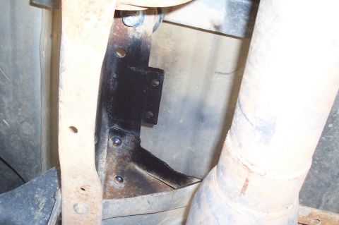1994 Ford F-150 - Underside view of a vehicle's exhaust pipe and frame bracket assembly.