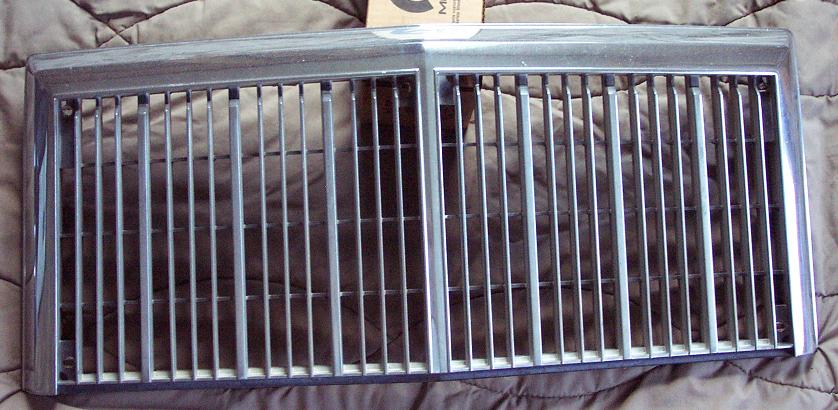 Chrome grille with vertical bars, a horizontal divider, and a silver frame