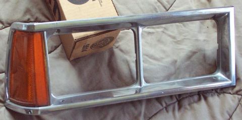 1985 Ford LTD Crown Victoria - Chrome headlight bezel with integrated amber turn signal, likely for a classic American sedan.
