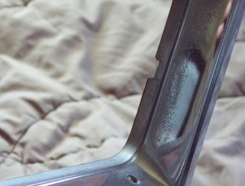 1985 Ford LTD Crown Victoria - Close-up of a chrome trim piece, showing signs of wear and corrosion.