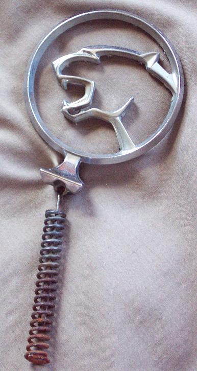 1985 Ford LTD Crown Victoria - This chrome emblem features a cougar design and is attached to a coiled spring.