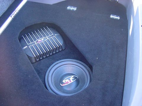 1997 Ford Probe - Custom black-carpeted trunk or hatch panel with an MTX subwoofer flush-mounted alongside a large finned MTX amplifier recessed into the fal…