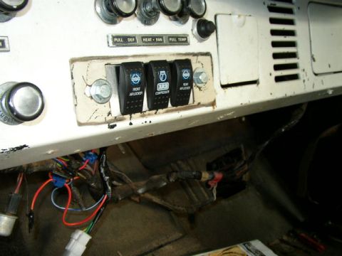 1995 Ford Bronco - Interior view of a white dashboard with aftermarket switches and visible wiring harness.