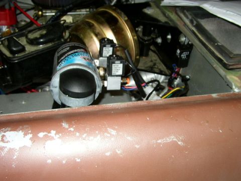 1995 Ford Bronco - Close-up of engine bay components including a brake booster and compressor.