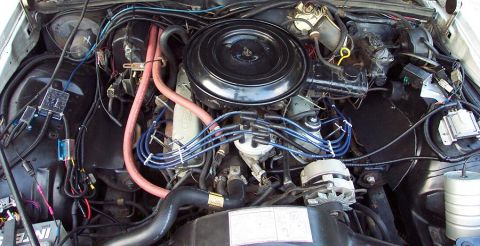 1985 Ford Crown Victoria LTD - The engine bay of a car is shown, the V8 engine and various components.