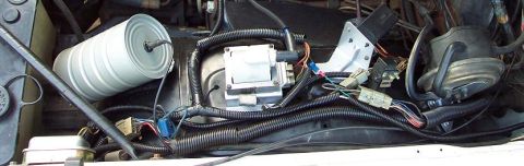 1985 Ford Crown Victoria LTD - Close-up view of various engine components, including a filter and ignition system.