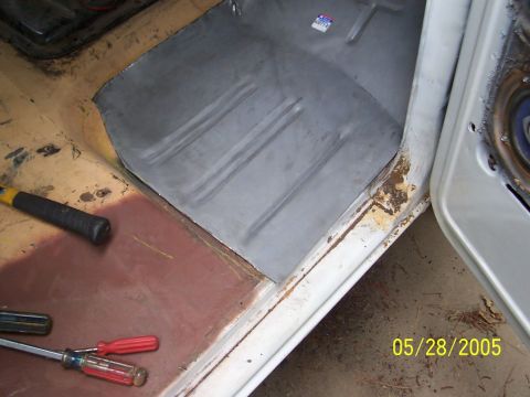 1979 Ford Bronco - Vehicle floor pan repair in progress, showing a new metal section and tools.