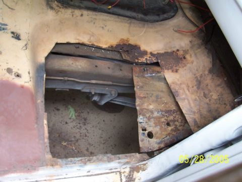1979 Ford Bronco - The vehicle's floor shows significant rust damage and a large hole.