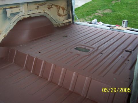 1979 Ford Bronco - The interior floor of a vehicle is coated in brown primer, revealing its ribbed construction.