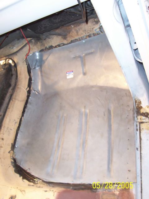 1979 Ford Bronco - The interior floor pan of a vehicle shows signs of repair and some rust.