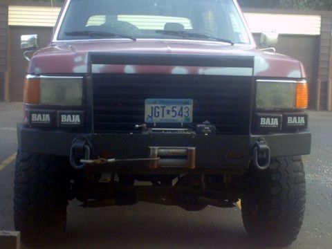 1989 Ford Bronco - This 1989 Ford Bronco features a custom bumper with a winch and 'Baja' decals on the headlights.