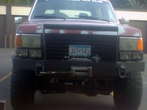 1989 Ford Bronco - This 1987 Ford Bronco has a custom bumper and winch, with visible primer under the red paint.