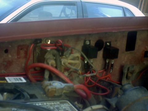 1989 Ford Bronco - Close-up view of the engine bay wiring harness and relays.