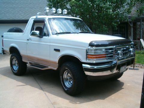 1996 Ford Bronco - This 1996 Ford Bronco is parked in a driveway with a house in the background.