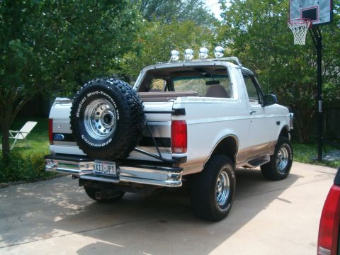 1996 Ford Bronco - This 1996 Ford Bronco is viewed from the rear, showing its spare tire, chrome bumper, and roof lights.
