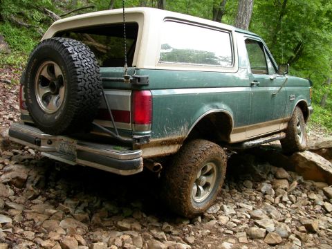 1990 Ford Bronco - 1990 Ford Bronco navigating a challenging rocky trail.