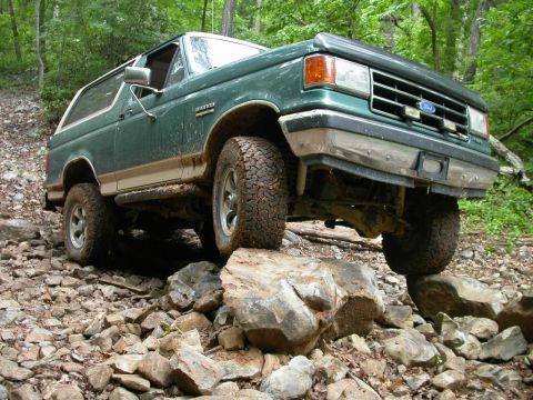1990 Ford Bronco - This 1990 Ford Bronco is shown off-roading over a challenging rocky path.