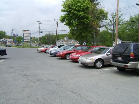 1998 Ford Taurus - A row of cars are parked in a lot with a Mobil and CVS in the background.