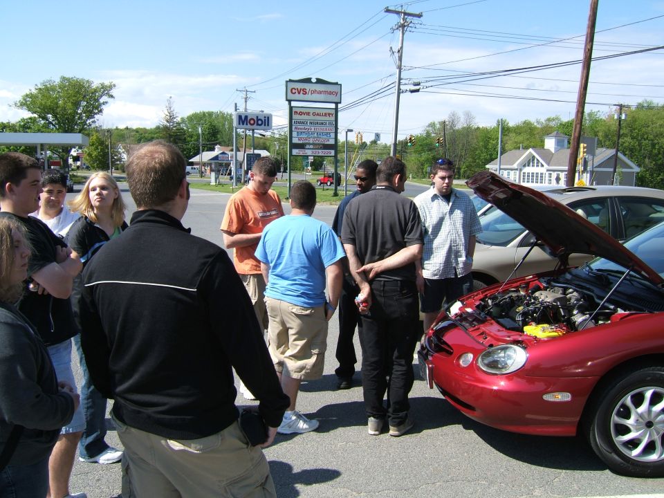 1998 Ford Taurus with hood open, viewed from front-right, red