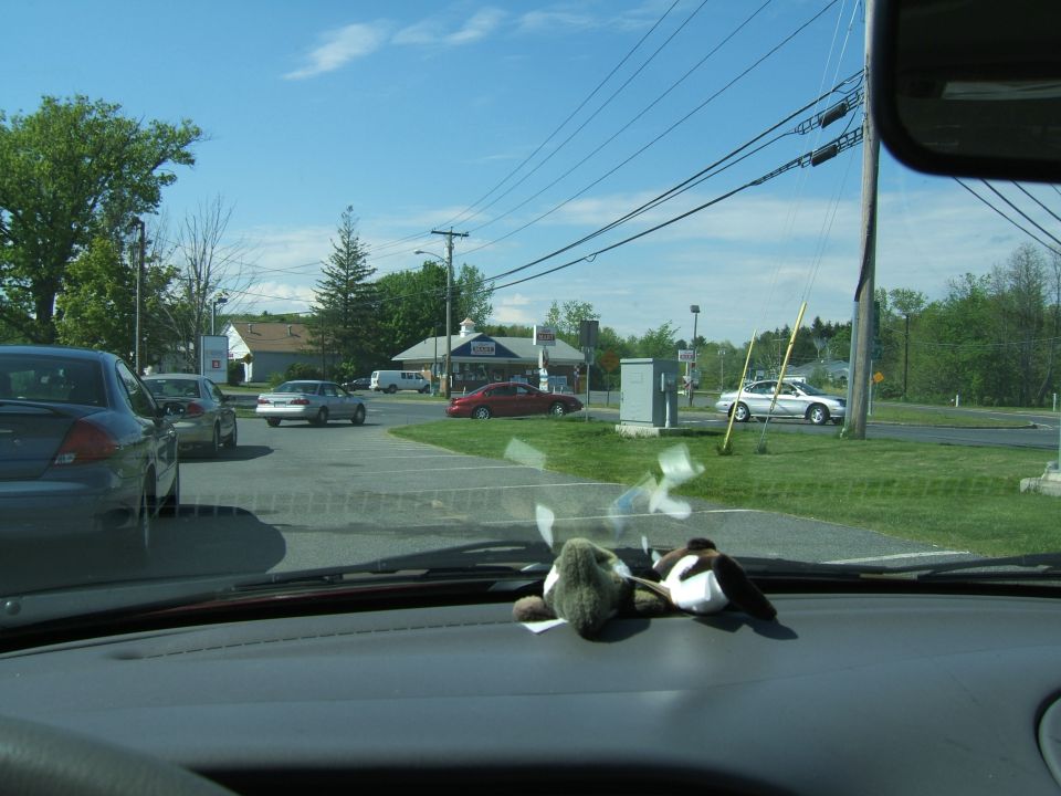 Silver 1998 Ford Taurus turning left at an intersection with a red car and other vehicles present