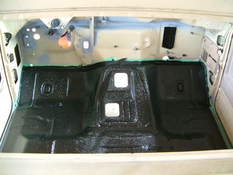 1985 Ford F-150 - The interior floor of a vehicle has been treated with black sound deadening material.