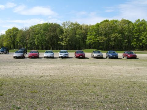1998 Ford Taurus - A group of sedans are parked in a lot on a sunny day.