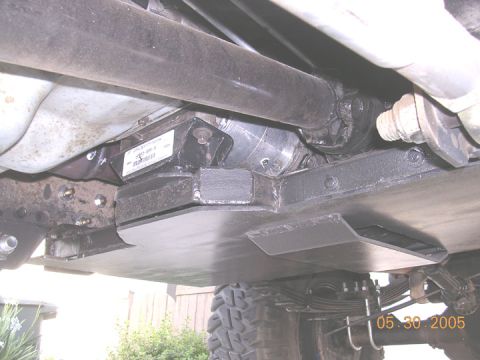1994 Ford Bronco - Close-up view of vehicle underbody, showing skid plate and drivetrain parts.