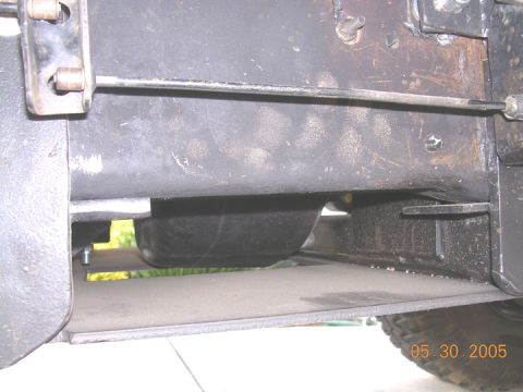 1994 Ford Bronco - Close-up view of the undercarriage of a vehicle, revealing mechanical components and a date stamp.
