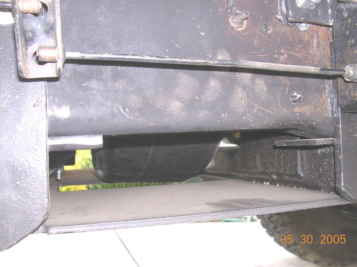 Steel rocker skid plate and frame rail under a primered truck body, 2005 date stamp