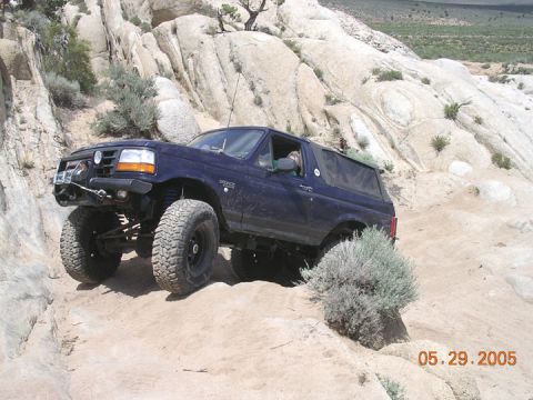 1994 Ford Bronco - Blue 1994 Ford Bronco tackling a challenging rocky terrain.
