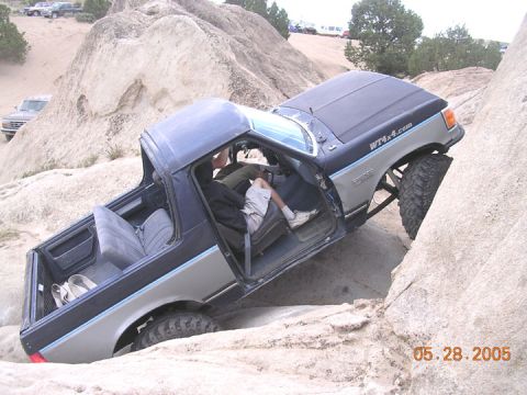 1994 Ford Bronco - A Ford Bronco is shown off-roading through a rocky landscape, with a date stamp of 05.28.2005.