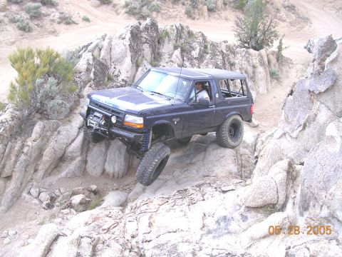 1994 Ford Bronco - A 1994 Ford Bronco tackles a challenging rocky terrain, demonstrating its off-road capabilities.