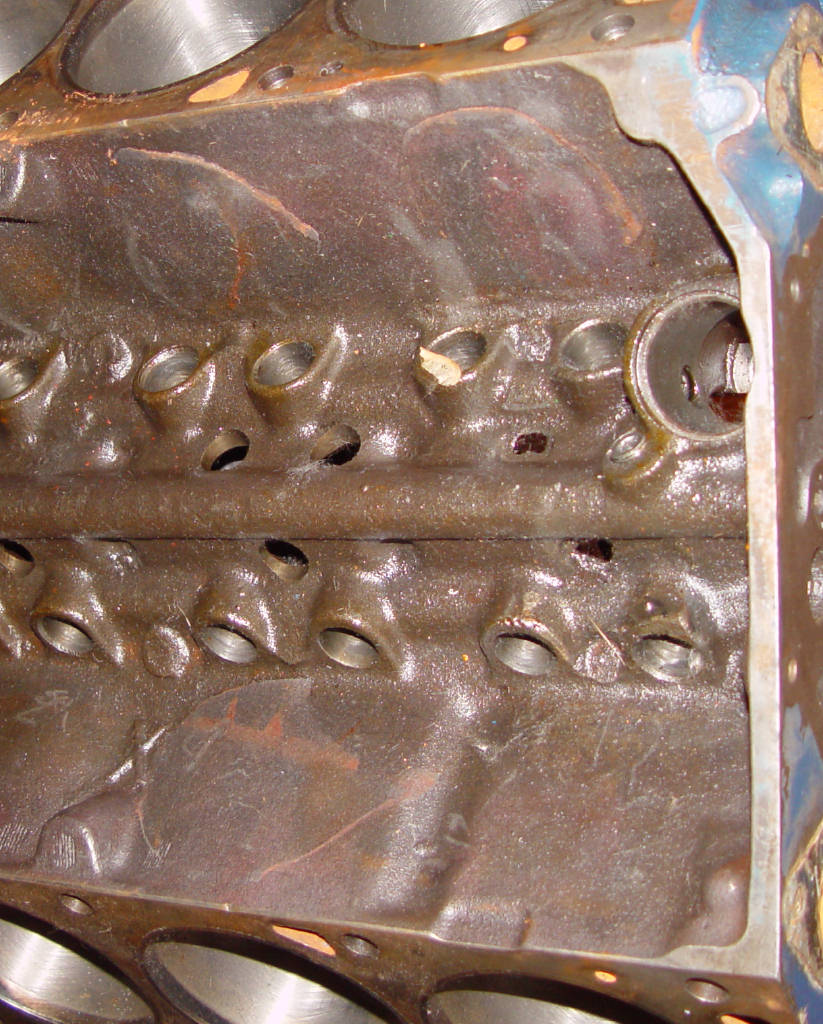 V8 engine block lifter valley with intake removed, showing lifter bores and bored cylinders