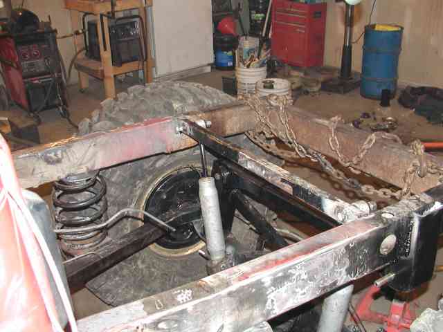 Close-up of vehicle frame and suspension with chains