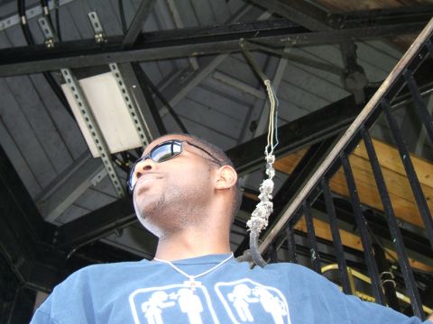 1998 Ford Taurus - A man is seen from a low angle, wearing sunglasses and a blue t-shirt with a graphic design.