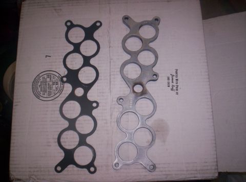 1989 Ford Bronco II - A new intake manifold gasket is shown next to an aluminum intake manifold.
