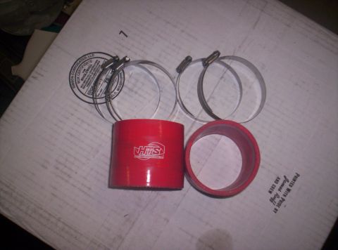 1989 Ford Bronco II - Red silicone coupler and hose clamps are laid out on a cardboard box.