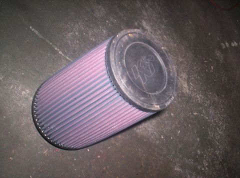 1989 Ford Bronco II - A K&N air filter is shown on a dark surface.