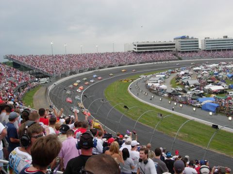 1995 Ford Bronco - Spectators watch a NASCAR race from the grandstands and infield camping areas.