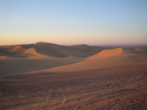 1968 Ford Mustang - Expansive desert landscape with rolling sand dunes illuminated by the setting sun.
