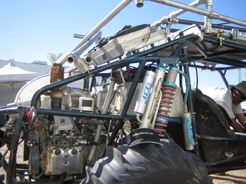 1968 Ford Mustang - Close-up of a custom off-road buggy's engine and suspension system, large tires and a roll cage.