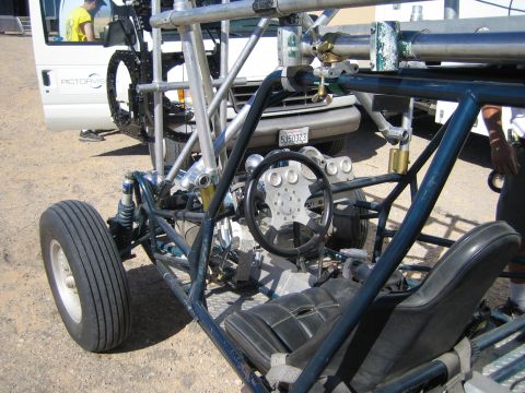 1968 Ford Mustang - This off-road buggy has a custom roll cage and a simple interior, with a van visible in the background.