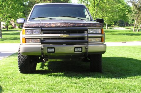 2000 Chevrolet Tahoe - This Chevrolet pickup truck features a prominent brush guard and a camouflage bug deflector on the hood.