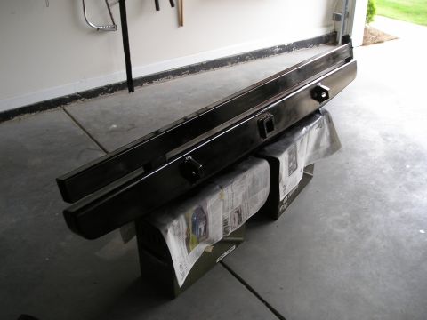 1996 Ford Bronco - Aftermarket steel bumpers with hitch receivers are shown resting on boxes covered with newspaper.