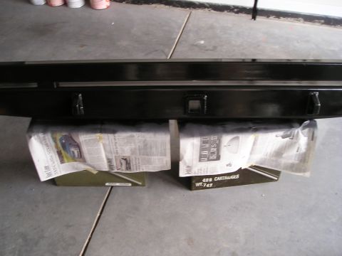 1996 Ford Bronco - A black rear bumper is shown resting on ammo cans covered with newspaper.