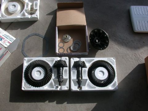 1994 Ford Bronco - Differential gears and installation kit components are displayed on a concrete surface.