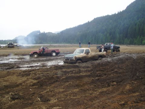 1985 Ford F-150 - Several trucks are stuck in the mud during an off-road event.